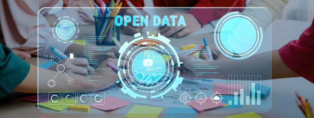 A diverse team engages in collaborative data analysis for an open data project, featuring digital elements, colorful stationery, and creative brainstorming